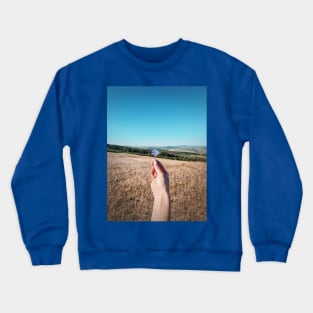 hand holding a chicory flower Crewneck Sweatshirt